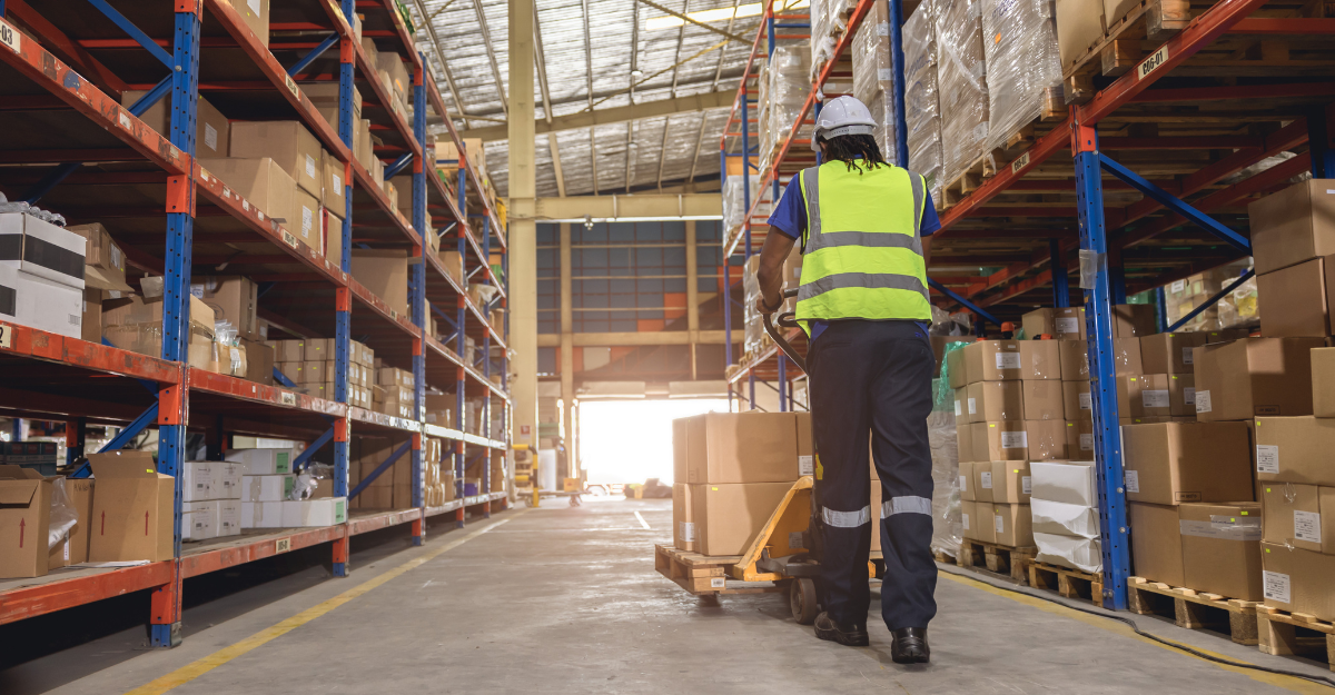 a bustling warehouse, highlighting workers loading both full and partial truckloads, demonstrating the PTL shipping process.