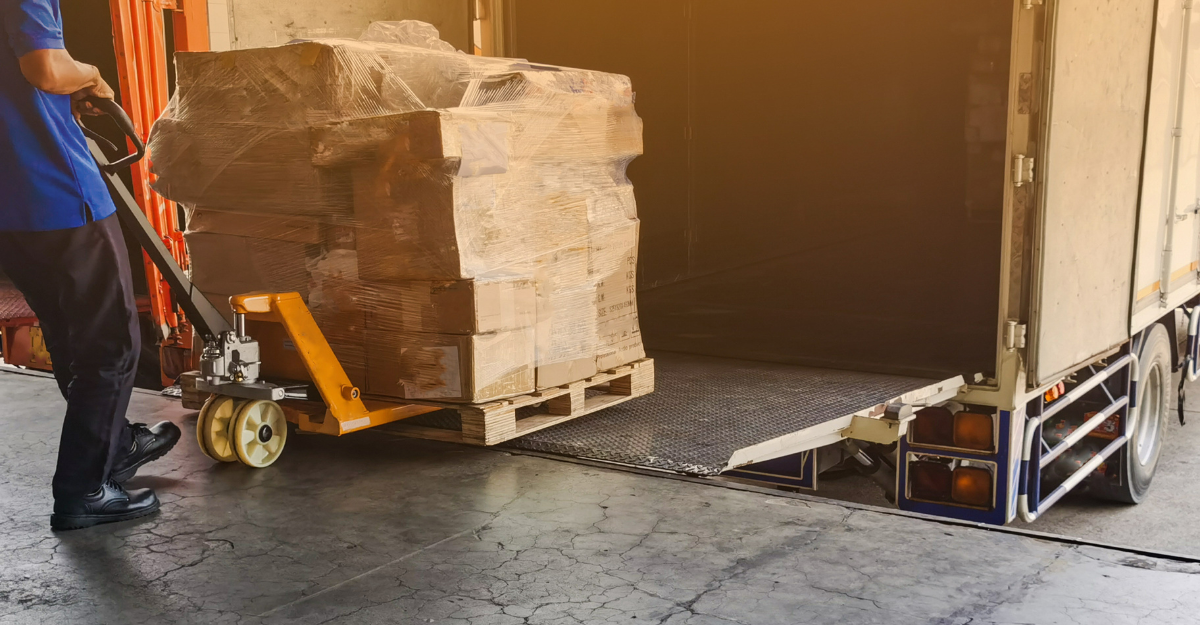 Warehouse worker filling partial truckload, demonstrating PTL shipping.